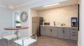 Cary apartment for rent - a kitchen with a counter and a refrigerator and a table