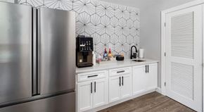 Raleigh apartment for rent - a kitchen with white cabinets and a stainless steel refrigerator