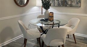 Greenville apartment for rent - a dining room table with white chairs and a vase