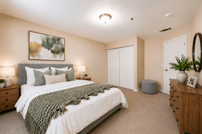 Decatur apartment for rent - A bedroom with a large bed and a painting on the wall.