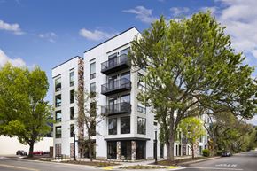 Sacramento apartment for rent - a rendering of a white apartment building on a city street