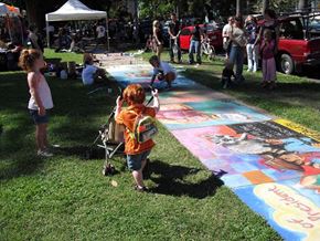 Sacramento apartment for rent - a little boy standing in the grass with a stroller