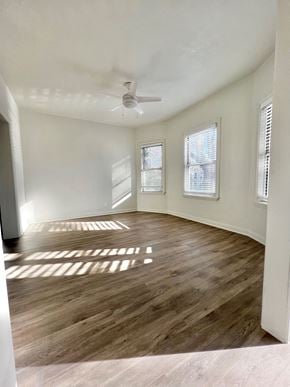 Sacramento apartment for rent - A room with wooden flooring and a ceiling fan.