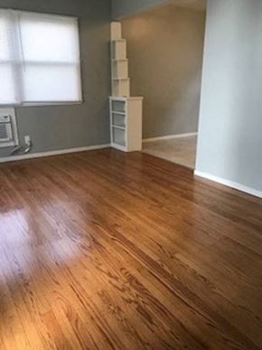 Sacramento apartment for rent - A room with wooden flooring and a white shelf.