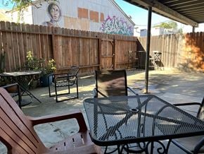 Sacramento apartment for rent - a patio with a table and chairs and graffiti on a fence