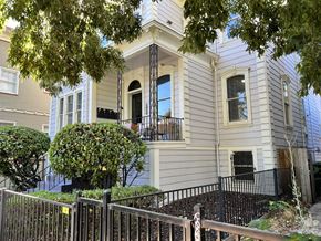 Sacramento apartment for rent - a white house with a balcony and a black fence