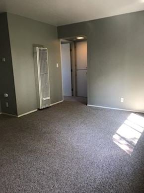 Sacramento apartment for rent - A room with grey carpet and a white door.