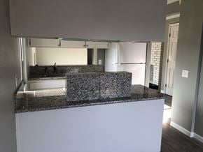 Sacramento apartment for rent - a kitchen with a granite counter top and a refrigerator