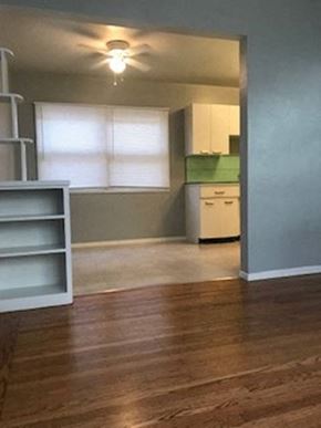 Sacramento apartment for rent - A room with a wooden floor and a ceiling fan.