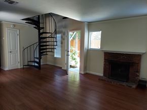 Sacramento apartment for rent - A room with a spiral staircase and a fireplace.