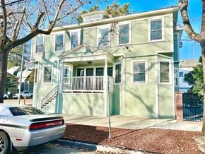 Sacramento apartment for rent - A green two-story house with a car parked in front.