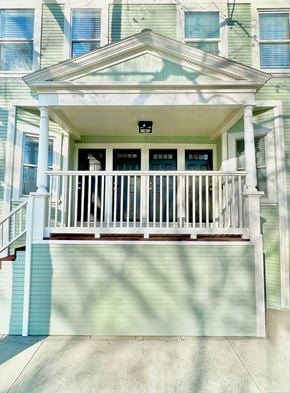 Sacramento apartment for rent - A green house with a white porch and a black mailbox.