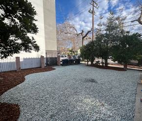 Sacramento apartment for rent - A gravel area with a fence and trees in the background.