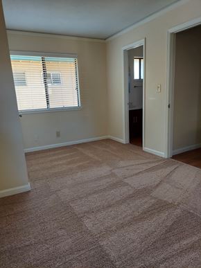 Sacramento apartment for rent - A room with a carpeted floor and a window with blinds.