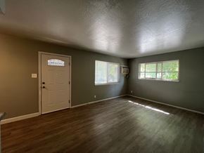 Sacramento apartment for rent - the living room of an empty house with a door and window