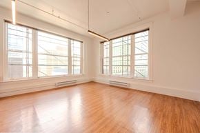 Denver apartment for rent - A room with wooden floors and large windows.