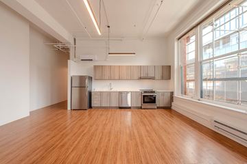 Denver apartment for rent - A kitchen with wooden floors and stainless steel appliances.