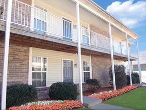 Louisville triplex for rent - A house with a blue door and a white railing.