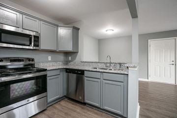 Bardstown apartment for rent - A kitchen with a stove top oven and microwave.
