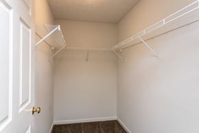 Bardstown apartment for rent - A white door is on the left of a room with a carpeted floor and two white shelves on the wall.