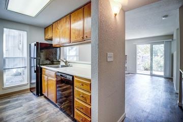 Fairfield apartment for rent - A kitchen with wooden cabinets and a refrigerator.