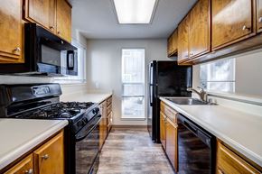Fairfield apartment for rent - A kitchen with black appliances and wooden cabinets.