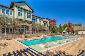 Huntersville apartment for rent - A large house with a pool in front.