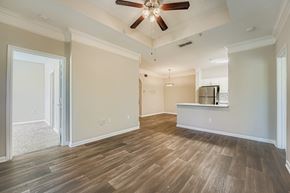 Alpharetta apartment for rent - A room with a ceiling fan and wooden flooring.