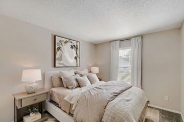 Canal Winchester apartment for rent - A bedroom with a bed, nightstand, and a painting on the wall.