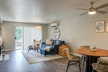 Lake Oswego apartment for rent - A living room with a blue couch and a wooden table.