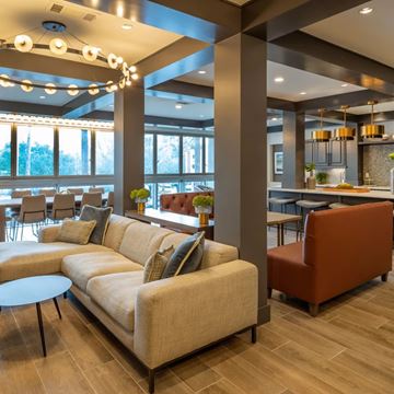 Houston apartment for rent - A modern living room with a large couch and a coffee table.