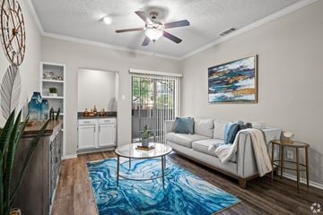 Dallas apartment for rent - A living room with a white couch and a blue rug.