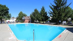 Canal Winchester apartment for rent - a large swimming pool with trees in the background
