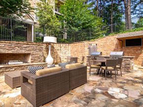 Alpharetta apartment for rent - A patio with a couch, chairs, and a table.