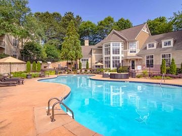 Alpharetta apartment for rent - A large house with a pool in the backyard.