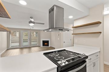 Wilsonville apartment for rent - A modern kitchen with a stove top oven and a range hood.