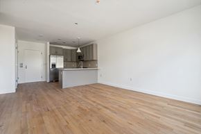 North Bergen apartment for rent - an empty living room and kitchen with wood flooring