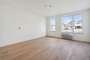 North Bergen apartment for rent - the living room of an apartment with wood flooring and large windows