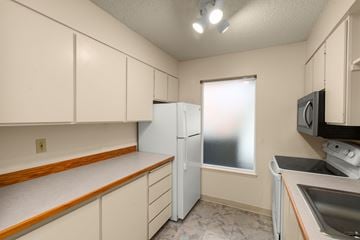 Portland apartment for rent - A kitchen with a refrigerator, microwave, and sink.