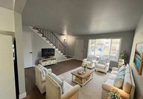 Milwaukie townhouse for rent - A living room with a staircase and a television.
