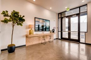 Portland apartment for rent - A room with a potted plant, a bench, and a painting on the wall.at Holm at Sellwood, Oregon