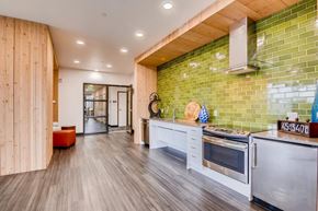 Portland apartment for rent - A kitchen with a green tiled wall and white appliances.at Holm at Sellwood, Oregon