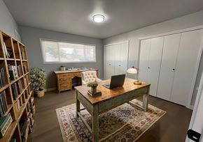 Milwaukie townhouse for rent - A room with a desk, laptop, and bookshelf.