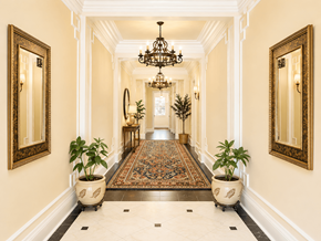 Portland apartment for rent - A long hallway with a rug and potted plants on either side.