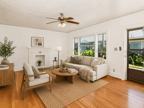 Portland triplex for rent - A living room with a fireplace, a sofa, a chair, a coffee table, and a potted plant.