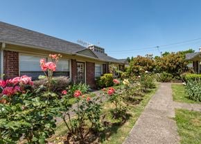 Portland triplex for rent - A house with a garden in front of it.
