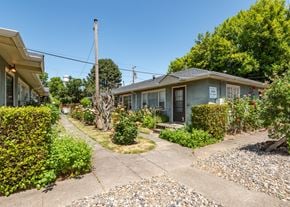 Portland triplex for rent - A residential area with a house and a garden.