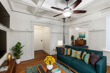 Portland apartment for rent - A living room with a green couch and a ceiling fan.