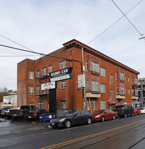 Portland apartment for rent - A red brick building with a sign that says Radio Cab. at Midtown Apartments, Oregon