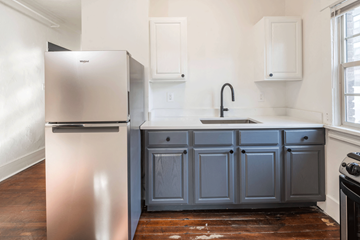 Portland apartment for rent - A kitchen with a stainless steel refrigerator and a grey cabinet.